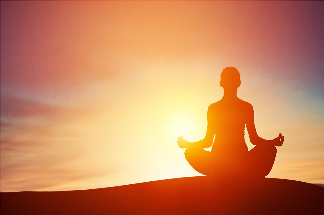 A person meditating in the sunlight