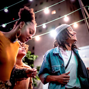 3 people dancing at a concert
