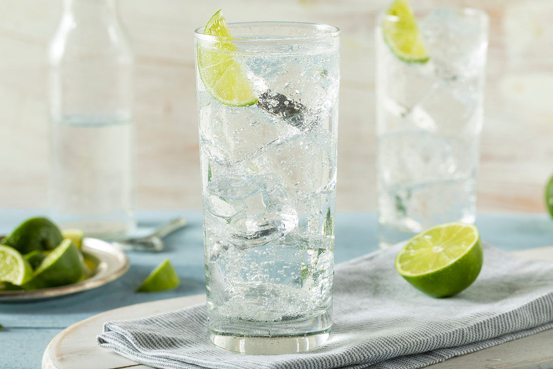 2 glasses of sparkling waters with a slice of lime 