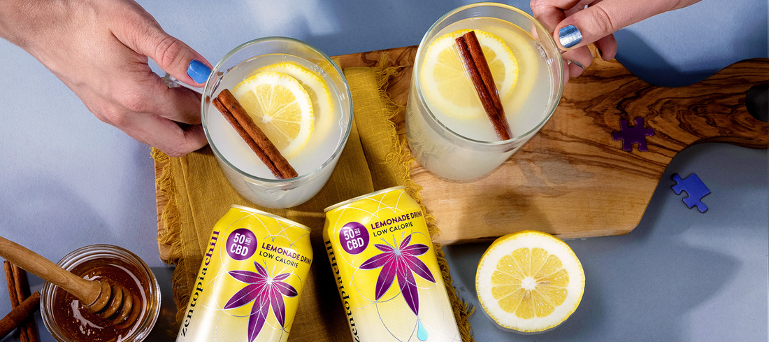 A cans of Zentopia Huckleberry Lemonade and tow glasses of Huckleberry Hot Toddy CBD Mocktail