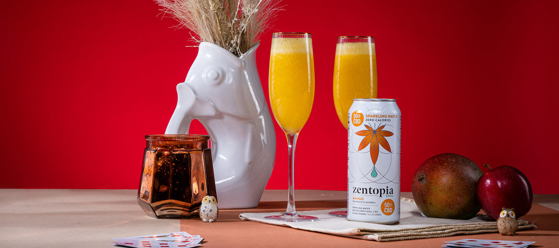 A can of Zentopia Mango CBD Chill and two champagne flutes mango Cider Bellini Mocktail