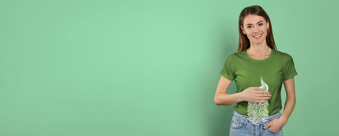 A woman in a green shirt holding her stomach 